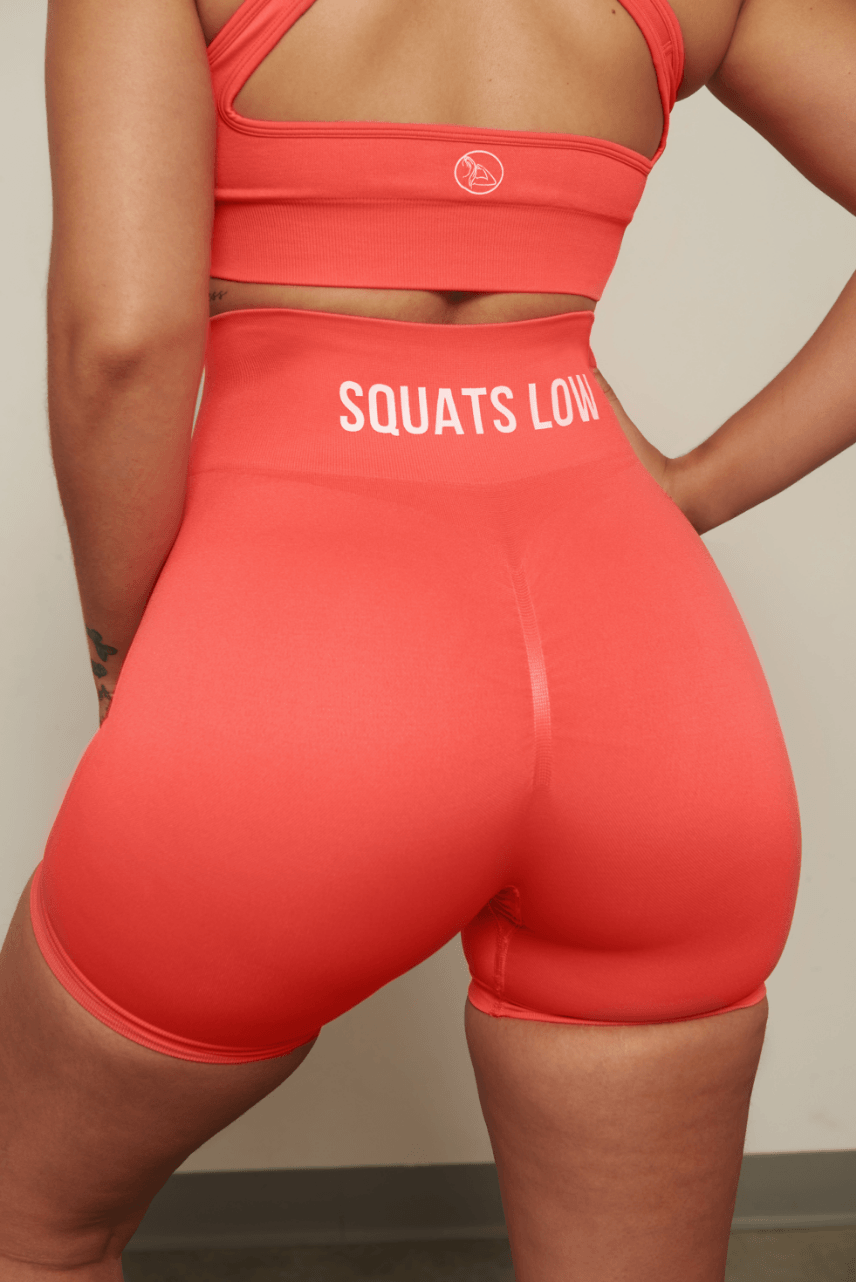 Keep your Standards High & Squats Low & stand the f*ck out out in the weight room in our Coral Squats Low Seamless Scrunch Shorts